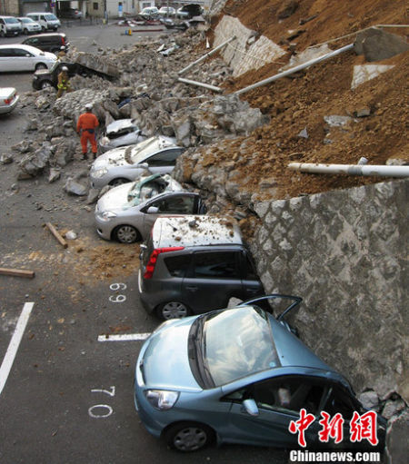 资料图： 日本近海3月11日发生了强烈地震，首都东京震感强烈。图为茨城县某停车场的车辆被倒塌的墙壁压毁。